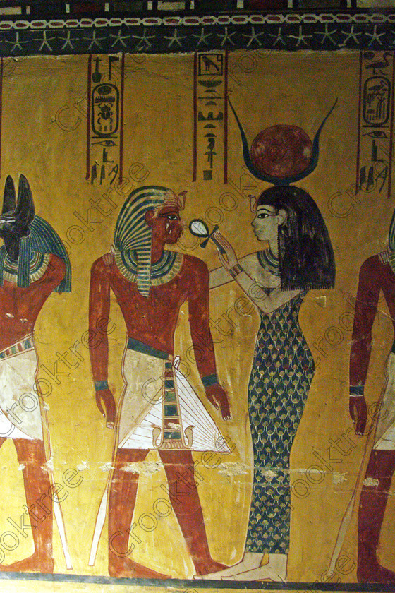 Valley Kings EG0213059jhp 
 Egypt Valley Kings Luxor Thutmosis Tomb Hathor ankh cartouche solar disk in the Valley of the Kings on the West Bank of the River Nile at Luxor which was robbed in antiquity and later restored by Horemheb through his official Maya. In the Tomb-Chamber is a red granite sarcophagus with still very brilliant colourful decoration as illustrated in the photo of the Goddess Nephthys.
Thanks to the capability of the modern digital camera and adjustments in Photoshop reasonably accurate colours can be exhibited of tomb paintings lit by low level artificial light when tripods and flash are not allowed such as the head of Anubis. This was taken before the current ban on tomb photography was introduced when you could purchase a ticket to photograph in two tombs in 2002. Unfortunately most of the photos of the painting had to be taken through Perspex which diminishes their quality as it obvious in several cases. 
 Keywords: Egypt, Luxor, West Bank, Thebes, Theban, Valley Kings, pharaoh, Tuthmosis, Thutmose, 1V, tomb, KV43, upright, Osiris, bearded, hedjet, white, crown, was, septer, ankh, Anubis, Hathor, jackal, head, painting, colourful, colorful, colours, colors, black, yellow, white, necklace, bright, ancient, Egyptian, archaeology, Egyptology, hieroglyphics, hieratic, writing, Maya, restoration, text, death, burial, Nut, nightsky, mythology, afterlife, sarcophagus, Nephthys, out-stretched, granite, chamber, antechamber, interiors, austere, undecorated, columns, stars, ceiling, history, hieroglyphs