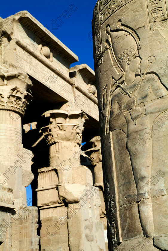 Kom Ombo Temple EG052483JHP 
 Kom Ombo Ptolemaic Temple Ancient Egyptian God Osiris Crown Atef carving on the River Nile just north of Aswan and a regular visit on all Nile Cruises, was principally built by Ptolemy V of Silsilah sandstone. Dedicated to two Gods – Sobek, the crocodile and Horus, the falcon and although it has been damaged over the years, mainly through slipping into the River Nile and some structural damage owing to earthquakes, there are still some wonderful colourful reliefs of the most detailed and delicate style. 
 Keywords: Egypt, East Bank, River Nile, Kom Ombo, Temple, hypostyle hall, hierogylphs, flail, columns, bas reliefs, coloured, colored, colours, colors, Silsilah, sandstone, upright, history, archaeology, ancient, Egyptian, Egyptology, Ptolemaic, Osiris, Hathor, carvings, detailed, delicate, beautiful, fine