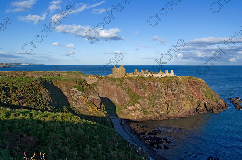 Dunnottar Castle Scotland VS2929JHP 
 Dunnottar Castle ruined Scottish fortress on a strategic rocky outcrop south of Stonehaven, viewed over Old Hall Bay which is reached by crossing over a step gorge called St Ninian's Den.
As a private property these photographs should only be used for tourist/scenic/editorial purposes. If required for commercial promotion then permission should be obtained from the owners by contacting The Factor; Dunecht Estates Office; Dunecht; Skene; AB32 7AX. Telephone: 01330 860223. 
 Keywords: Scotland, Scottish, Aberdeenshire, North, east, sea, Stonehaven, Kincardineshire, north, Dunnottar Castle, haven bay, castle, Dunnottar, Castle, landscape, panorama, spectacular, coast, coastal, cliffs, rocks, headland, bay, Haven, Benholm, Lodging, keep, tower, curtain, portcullis, vaulted, pends, arched, window, stonework, weathered, erosion, conglomerate, pudding, stone, Dun, Fother, 14th, century, Marischal, storehouse, smithy, bakery, brewery, stables, guardhouse, quadrangle, well, mansion, chambers, chapel, Whig's Vault, prison, dungeon, siege, Honours, jewels, Covenanters, exhibition, fortress’ ‘benholm lodging’, dun, fother, marischal, whig's vault