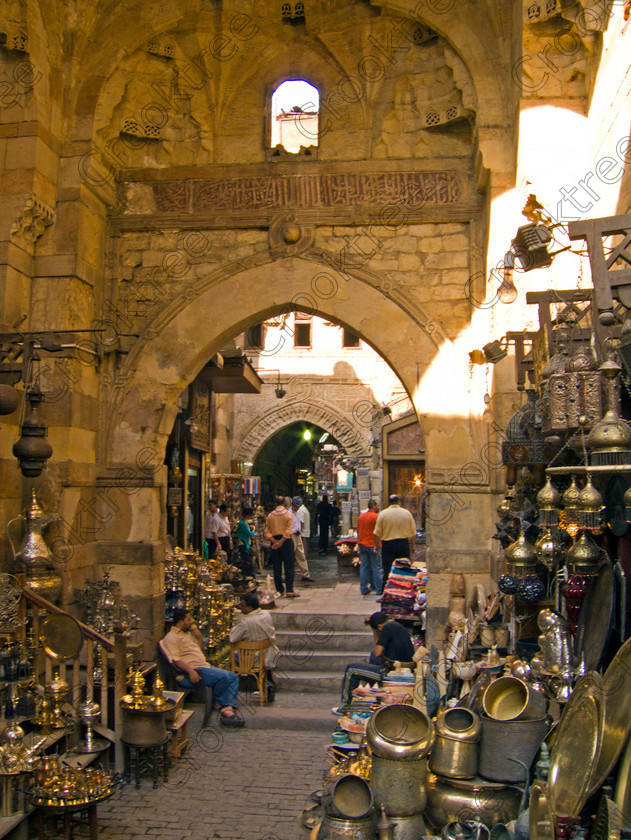 Cairo Khan al-Kalili EG072622jhp 
 Egypt Cairo Kan al-Khalili souk alleyway old historic pots brass metalware Egyptian in a busy and often important site seeing stop-off for tourists to Egypt and offered as part of City Tour where many bargains can be picked up as part of that exotic shopping experience in an Arabic Bazaar. Bargaining is also part of the fun and is expected throughout so a new and often daunting experience for the traditional conservative British visitor. Better value can probably be obtained in Aswan or Luxor and certainly for those doing a Nile Cruise large, weighty or fragile items are best left to the last minute. 
 Keywords: Egypt, Egyptians, Cairo, cruise Arabic, bargaining, tourism, tourists, upright, capital, old, city, gates, Sultan, Qansuh, Fatimid, Kan al-Khalili, al-Kalili, souk, al-Badestan, maze, alleyways, alleys, shops, factories, bazaars, market, antiques, gold, jewellery, clothes, glass, leather, metal, wood, crafts, souvenirs, cafes, restaurants, sheeshas, trade, commercial, mosques, minaret, palm, trees, architecture, al-Azhar, Maydan, square, al-Hussein, Sayyidna, al-Husayn, building, 19C, Gothic