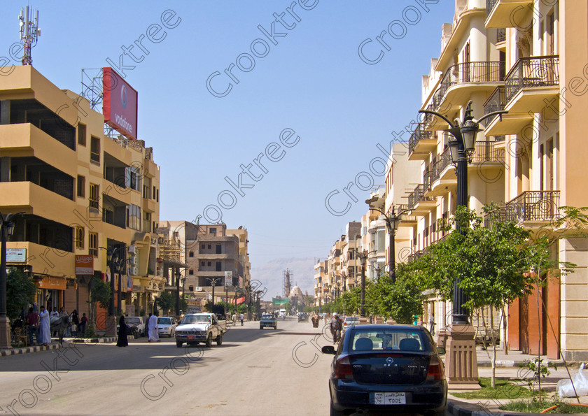 Luxor Station Street EG072586jhp 
 Egypt Luxor Station road riverbank houses stylish modern architecture Egyptian influence found along this long straight road Sharia al-Mahatta from just behind Luxor Temple and facing the elegant and modern railway station faade. We were dropped here before entering the station and boarding the main Aswan to Cairo train for a visit to the Minya area. One aspect of the traffic management that I thoroughly approved were the traffic lights at junctions with a clock showing how soon to the change of lights. 
 Keywords: Egypt, Thebes, Luxor, Waset, Ipetisut, East, Bank, River, Nile, Sharia, al Mahatta, landscape, road, station, platform, train, railway, Ramses, waterfront, promenade, esplanade, Corniche, modern, architecture, European, influence, style, stylish, balconies, Egyptian, theme, eye, wedjat, freize, cornice, construction, apartment, block, street, cars, people, tree-lined